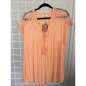 Orange oversized top with tassle and sheer details